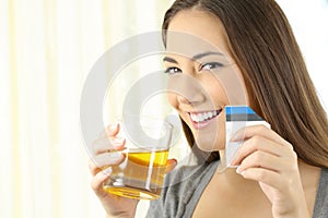 Woman posing with soluble medicine at home photo