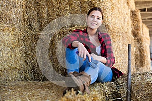 Woman posing at straw storage on farm