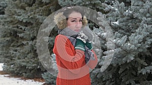 Woman is posing in winter forest, beautiful landscape with snowy fir trees