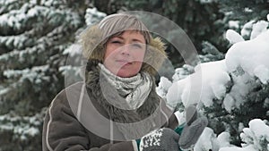 Woman is posing in winter forest, beautiful landscape with snowy fir trees