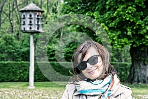 Woman posing with wooden dovecote, blue filter