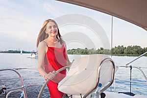 woman posing on the yacht at a sunny summer day at the river