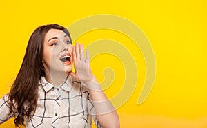 Woman posing on yellow and calling photo