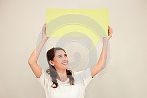 Woman, poster and happy in studio for promotion with mockup space for advertising, marketing and knowledge. Female