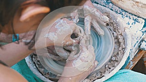 Woman Potter`s Hands Work with Clay on a Potter`s Wheel