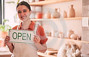 Woman, pottery art and small business with open sign for creative startup, welcome or entrepreneurship at retail store