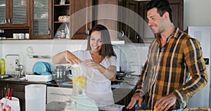 Woman Pour Water In Blender To Pineapple Talking With Man Couple In Kitchen Prepare Healthy Smoothie Juice Together