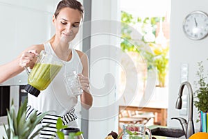 Woman pouring cocktail into jar