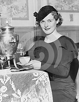 Woman pouring coffee from a coffee urn