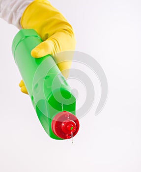 Woman pouring detergent from bottle on white background