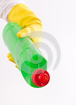 Woman pouring detergent from bottle on white background