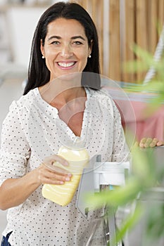 woman pouring detergent into washing machine