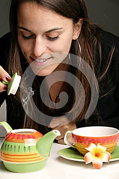 Woman pouring herself a cup of tea