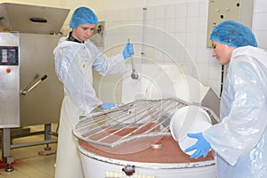 Woman pouring ingredient into vat