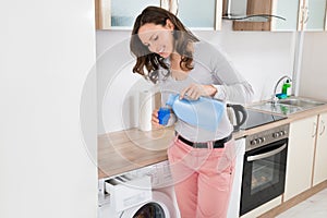 Woman Pouring Liquid Detergent In The Bottle Cap