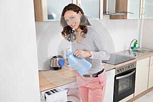 Woman Pouring Liquid Detergent In The Bottle Cap