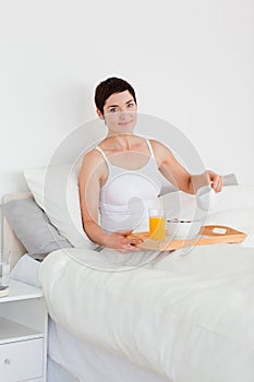 Woman pouring milk into her cereal