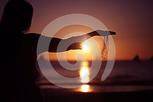 Woman pouring sand