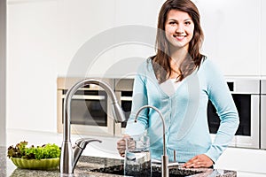 Woman pouring tap water