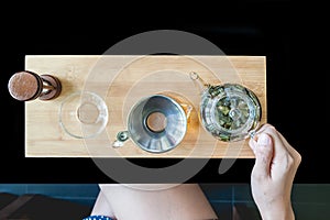 Woman pouring tea into a glass