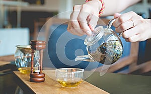 Woman pouring tea into a glass