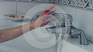 Woman pouring water into the bath