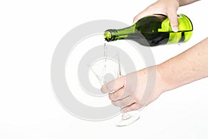 A woman pours a glass of white wine