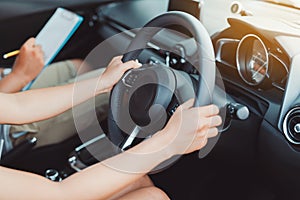 Woman practice driving car exam driver licence control steering wheel