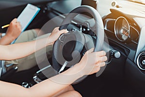 Woman practice driving car exam driver licence control steering wheel photo