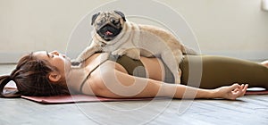 woman practice yoga with dog pug breed enjoy and relax with yoga at home