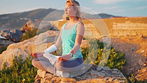 Woman practice yoga lotus pose to meditation with summer vacation rocky beach happiness and relaxation. Calm female