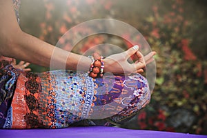 woman practice yoga meditation hands in mudra gesture closeup outdoor