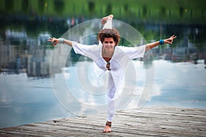 Woman practice yoga outdoor by the lake