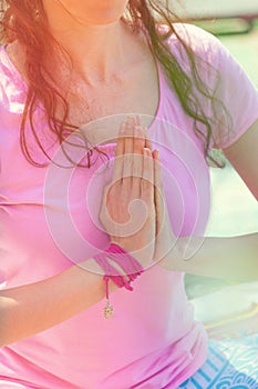 Woman practice yoga outdoor sunny spring summer day close up of hands in namaste gesture