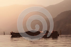 woman practice yoga on the pool above the Mountain peak