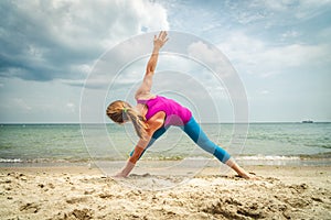 Woman practice yoga at the sea