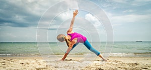 Woman practice yoga at the sea