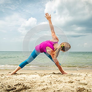 Woman practice yoga at the sea
