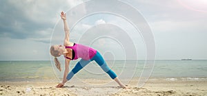 Woman practice yoga at the sea