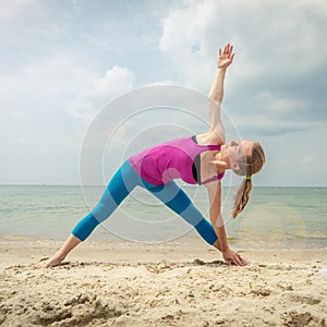 Woman practice yoga at the sea