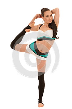 Woman practice yoga and stretches leg standing isolated over white