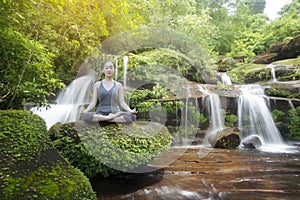 Woman practice yoga with waterfall