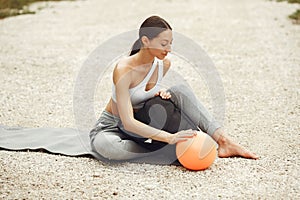 Woman practicing advanced yoga in a beach