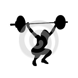 Woman practicing with barbell. Weight-lifting photo