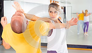 Woman practicing basic palm strike in self defense training