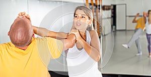 Woman practicing basic palm strike in self defense training