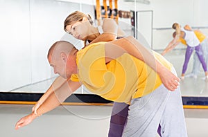 Woman practicing basic self defense movements with male partner