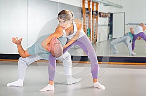 Woman practicing basic self defense skills in gym