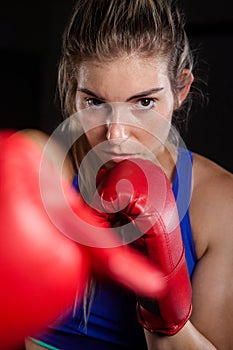 Woman practicing boxing in fitness studio