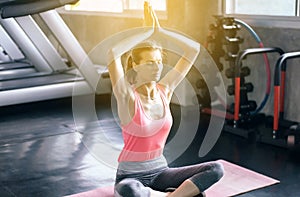 Woman practicing doing yoga exercise workout after in gym,Healthy and lifestyle concept